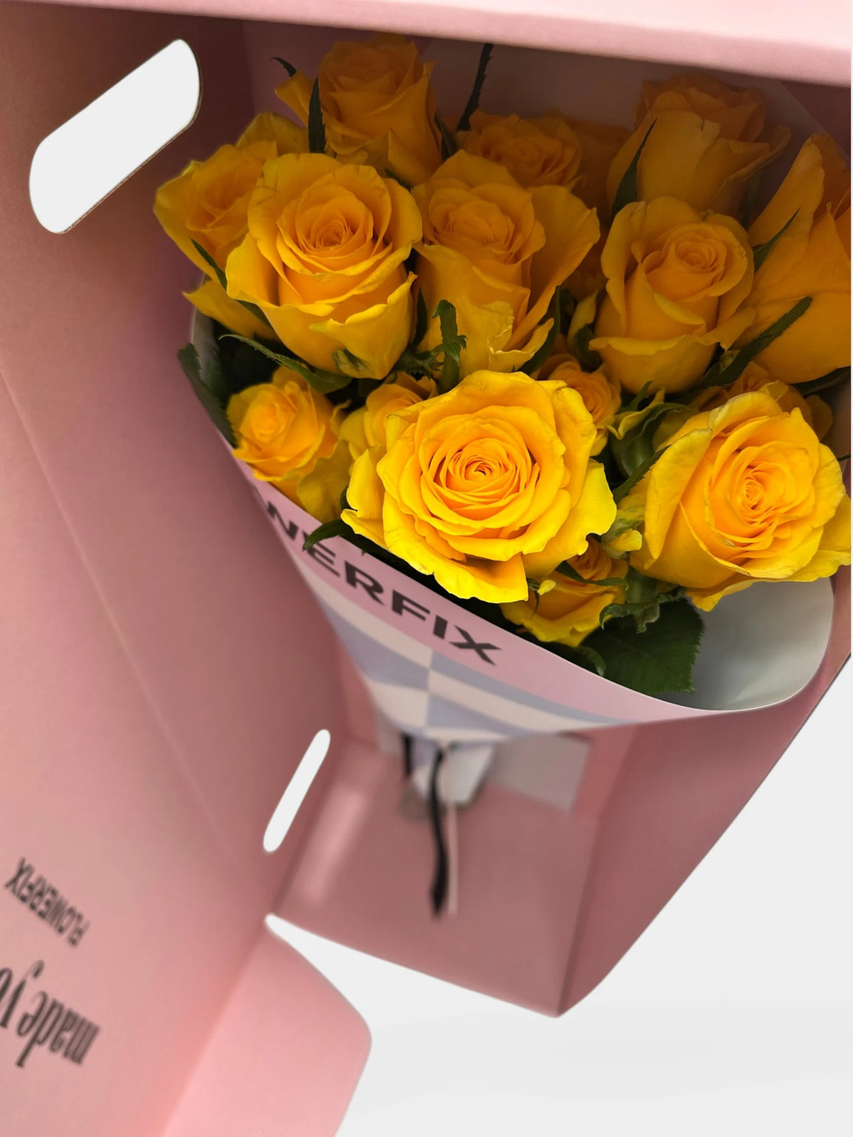 Bouquet of yellow roses in a pink box with 'Flowerfix' branding.
