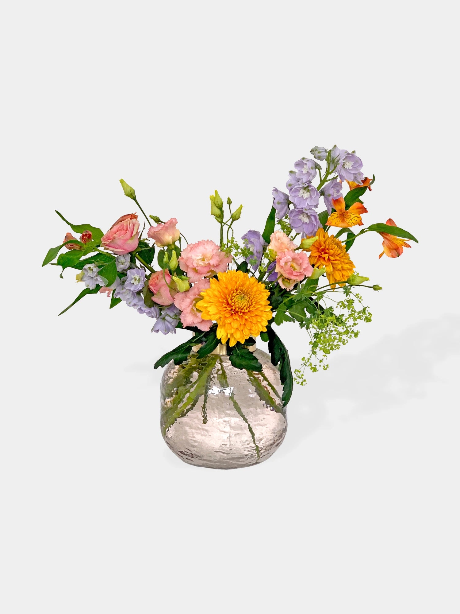 Bouquet of colorful flowers in a clear vase on a white background. A pet friendly bouquet by FLOWERFIX